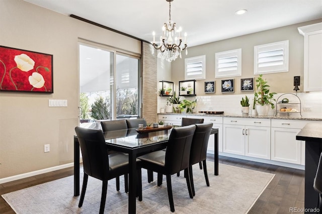 dining room featuring a chandelier and dark hardwood / wood-style floors