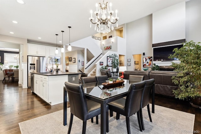 dining room featuring a notable chandelier, sink, and dark wood-type flooring