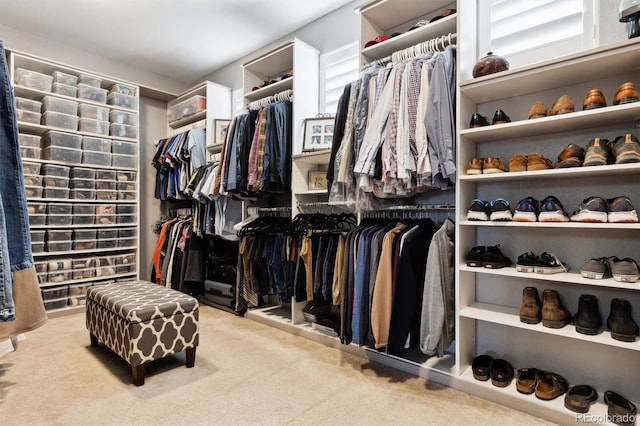 walk in closet featuring light colored carpet