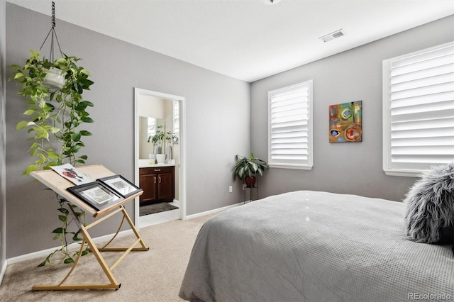 carpeted bedroom with ensuite bath