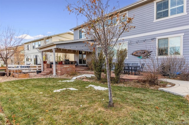 view of yard featuring an outdoor kitchen and a patio