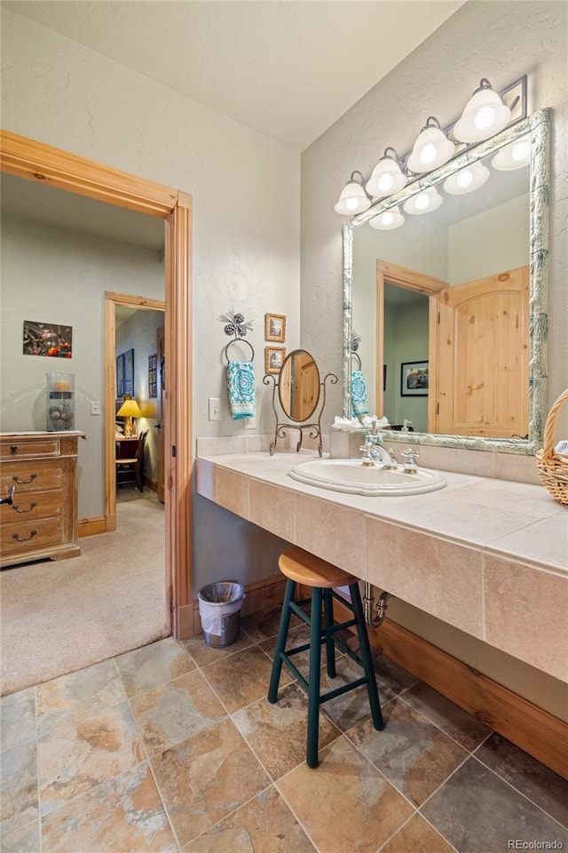 105 Windflower Ln, Frisco, CO 80443 - bathroom with stone finish flooring, vanity, and a textured wall