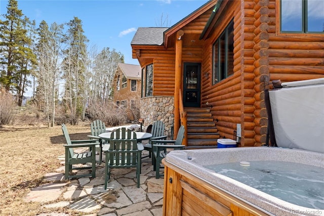 105 Windflower Ln, Frisco, CO 80443 - view of patio with a hot tub, outdoor dining area, and entry steps