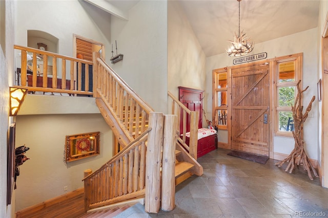 105 Windflower Ln, Frisco, CO 80443 - entryway with stairs, a chandelier, and high vaulted ceiling