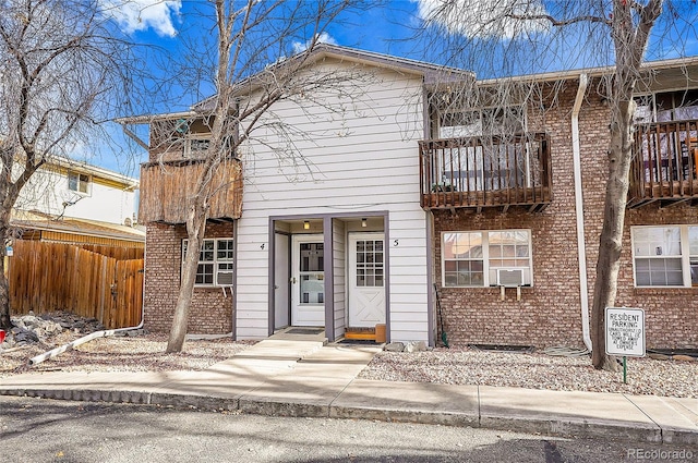 view of front of property with a balcony and cooling unit