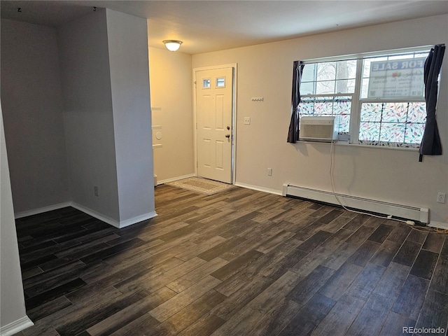 foyer entrance featuring baseboard heating and dark hardwood / wood-style floors