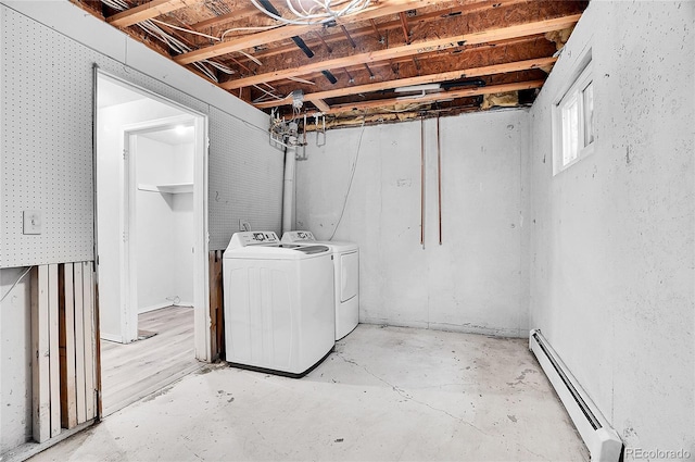 laundry room with separate washer and dryer and a baseboard heating unit