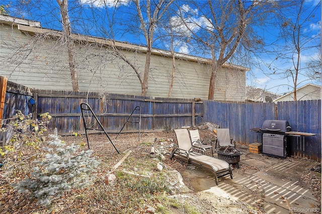 view of yard with an outdoor fire pit