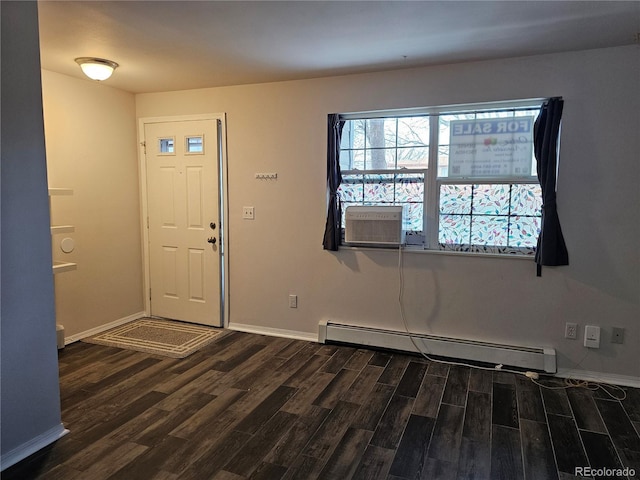 foyer entrance with cooling unit, dark wood-type flooring, and baseboard heating