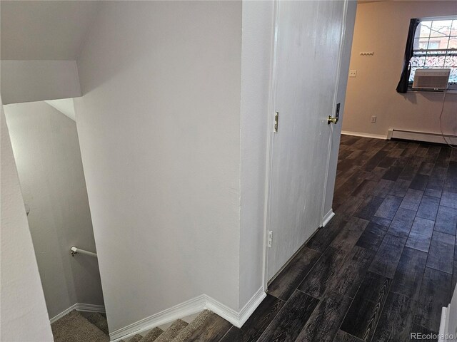 hallway featuring a baseboard radiator, dark wood-type flooring, and cooling unit