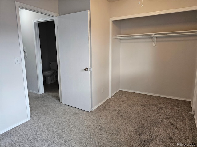 unfurnished bedroom featuring a closet and carpet flooring