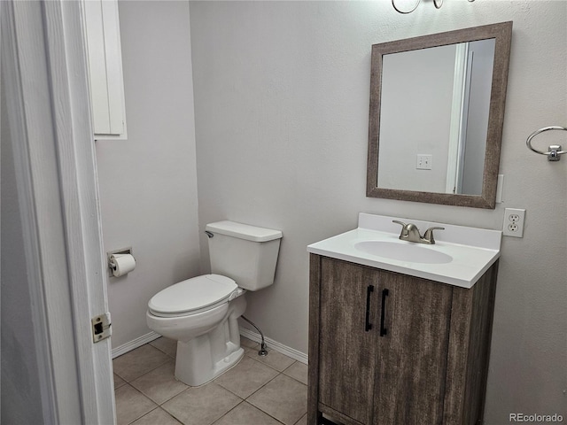 bathroom with vanity, toilet, and tile patterned flooring