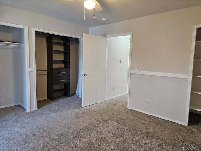 unfurnished bedroom featuring multiple closets, ceiling fan, and carpet floors