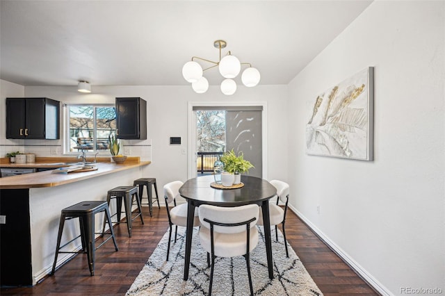 dining area with a chandelier and dark hardwood / wood-style floors