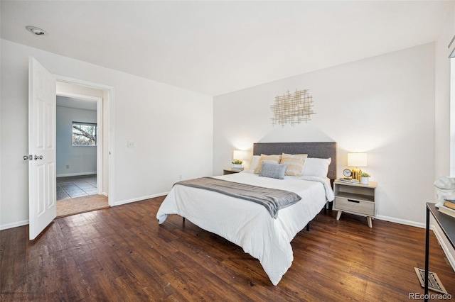 bedroom with dark hardwood / wood-style floors