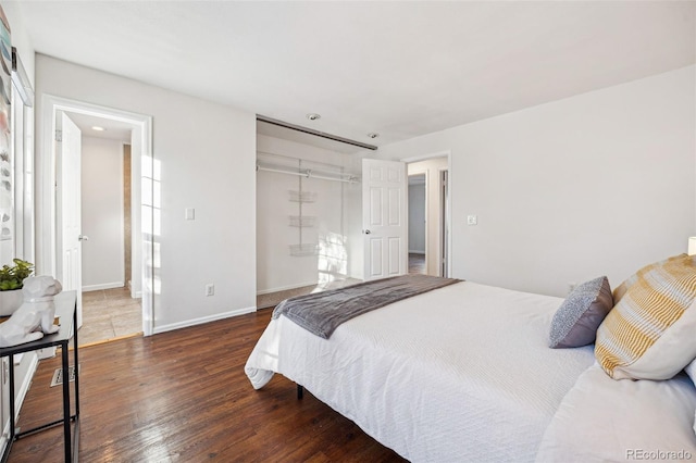 bedroom with a closet and dark hardwood / wood-style flooring