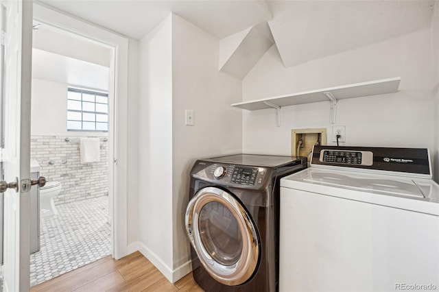 washroom featuring washer and dryer and light wood-type flooring