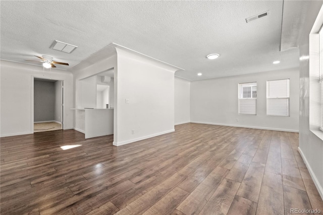 unfurnished living room with hardwood / wood-style flooring, a textured ceiling, and ceiling fan