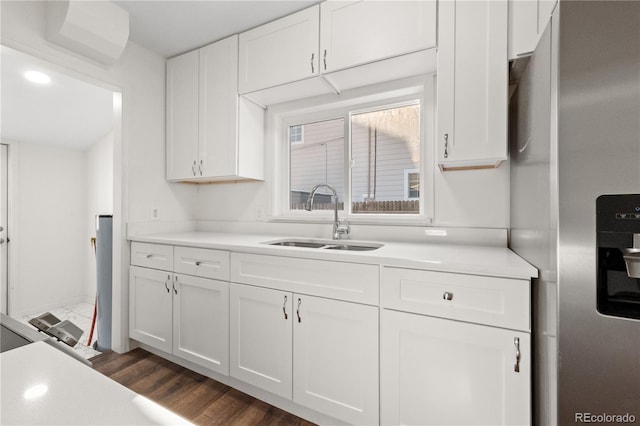 kitchen featuring stainless steel refrigerator with ice dispenser, sink, white cabinets, and dark wood-type flooring