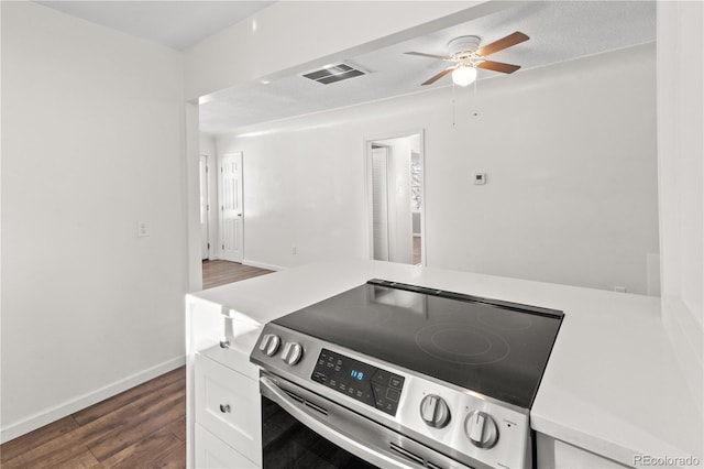 kitchen featuring ceiling fan, white cabinetry, dark wood-type flooring, a textured ceiling, and stainless steel range with electric stovetop