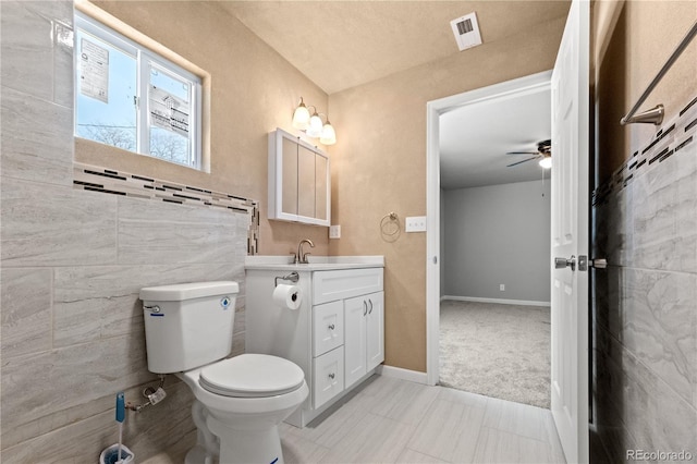 bathroom featuring ceiling fan, vanity, and toilet