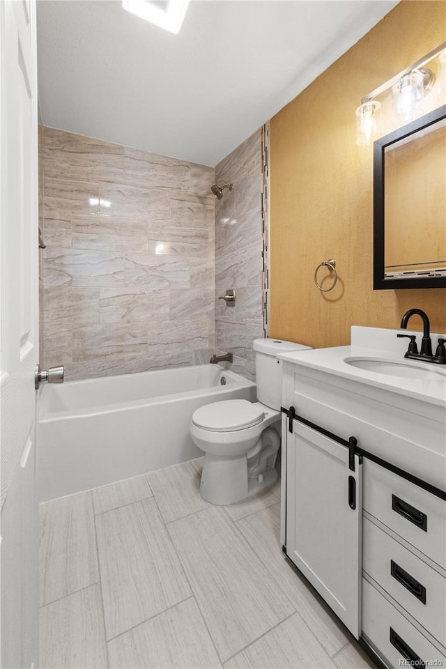 full bathroom with toilet, tiled shower / bath, and vanity