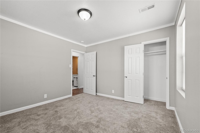 unfurnished bedroom with a closet, crown molding, and light colored carpet