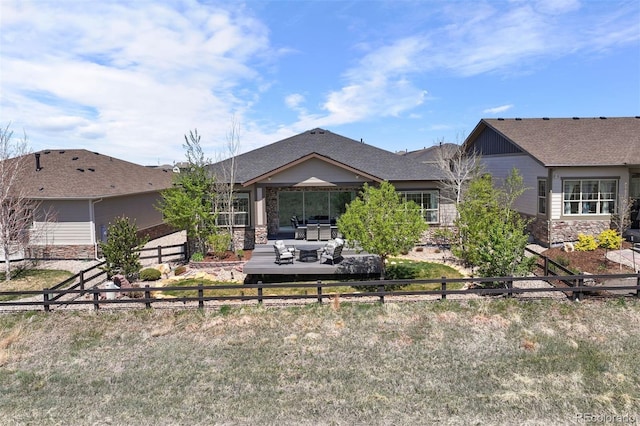 23030 E Del Norte Cir, Aurora, CO 80016 - rear view of house with stone siding and a fenced backyard