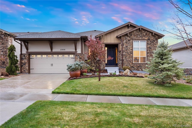 23030 E Del Norte Cir, Aurora, CO 80016 - view of front of home with board and batten siding, driveway, stone siding, and a front lawn