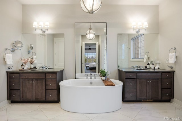 23030 E Del Norte Cir, Aurora, CO 80016 - ensuite bathroom with marble look tiles, a soaking tub, and two vanities