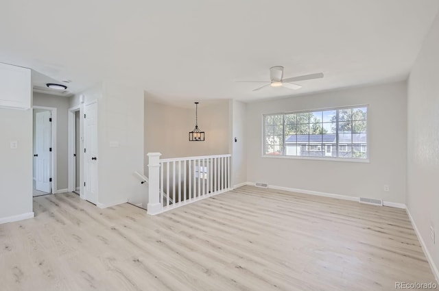 empty room featuring ceiling fan and light wood-type flooring