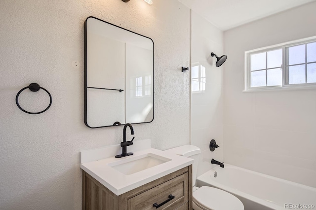 full bathroom featuring vanity, bathtub / shower combination, and toilet