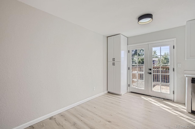 doorway to outside featuring french doors and light wood-type flooring