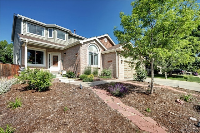 1313 Iris Cir, Broomfield, CO 80020 - view of front of home featuring driveway, an attached garage, and brick siding