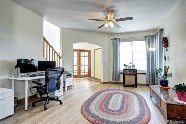 1313 Iris Cir, Broomfield, CO 80020 - home office featuring arched walkways, light wood finished floors, french doors, and a ceiling fan
