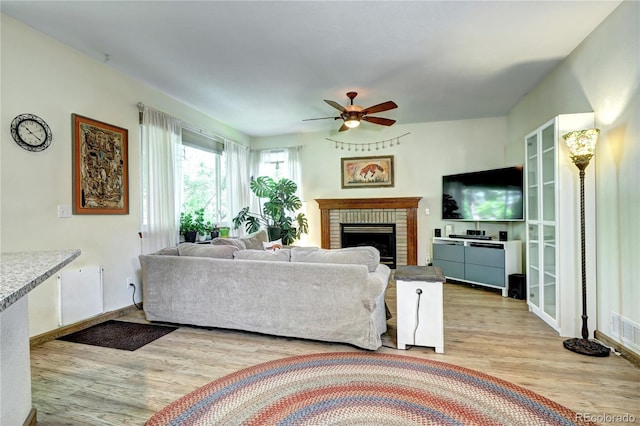 1313 Iris Cir, Broomfield, CO 80020 - living area with wood finished floors, a brick fireplace, and a ceiling fan