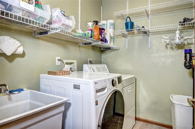 1313 Iris Cir, Broomfield, CO 80020 - washroom featuring washer and clothes dryer and light tile patterned floors