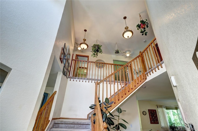 1313 Iris Cir, Broomfield, CO 80020 - stairway featuring a towering ceiling, a textured wall, and ceiling fan