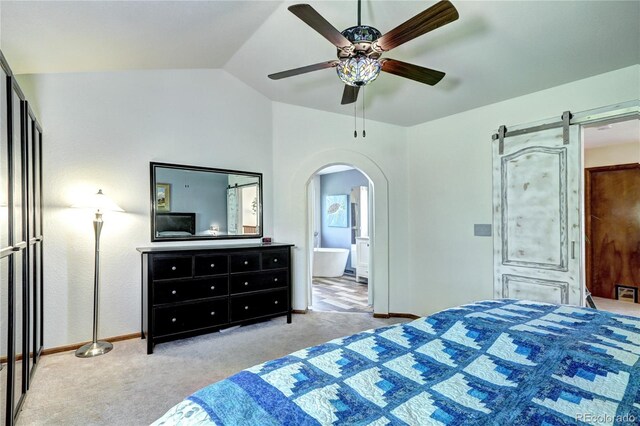 1313 Iris Cir, Broomfield, CO 80020 - carpeted bedroom with arched walkways, vaulted ceiling, ensuite bath, ceiling fan, and a barn door
