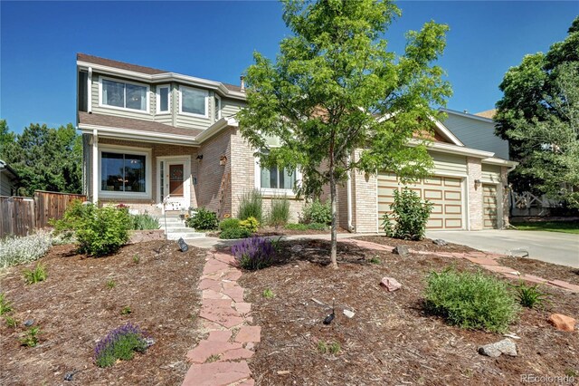 1313 Iris Cir, Broomfield, CO 80020 - view of front of home with brick siding, driveway, and a garage