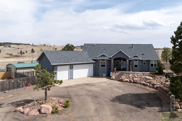 ranch-style house with a shingled roof, a garage, concrete driveway, fence, and stucco siding