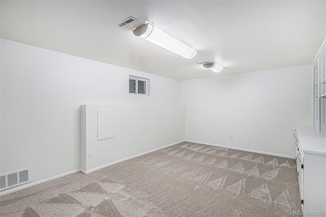 unfurnished room featuring baseboards, visible vents, and light colored carpet