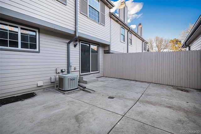 view of patio with entry steps, fence, and cooling unit