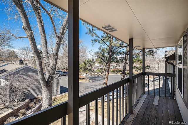 wooden terrace featuring visible vents