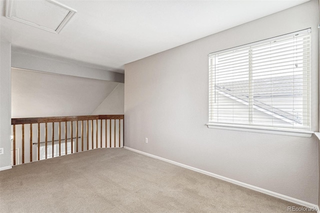 spare room with lofted ceiling, carpet, visible vents, and baseboards