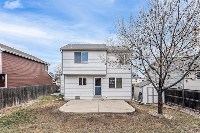 back of property featuring an outbuilding, a storage unit, a patio area, and a fenced backyard