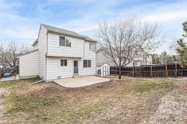 rear view of house with an outbuilding, a lawn, a patio area, a shed, and a fenced backyard