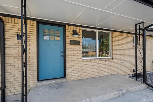 property entrance with brick siding