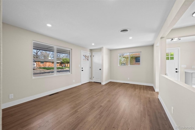 spare room featuring visible vents, wood finished floors, baseboards, and recessed lighting