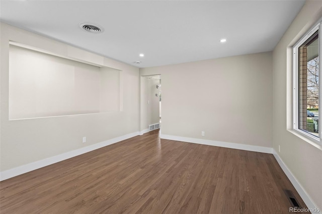 unfurnished room with baseboards, recessed lighting, visible vents, and wood finished floors